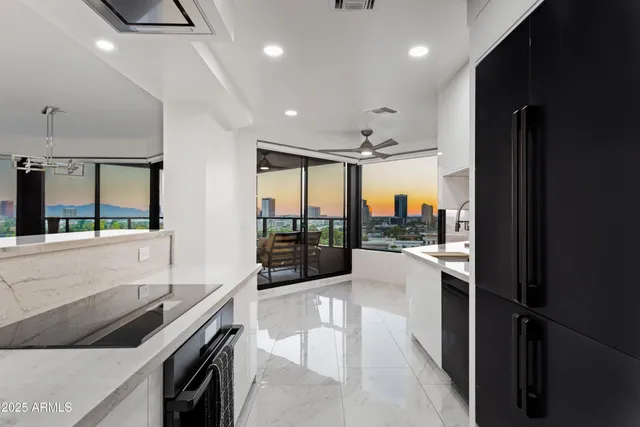 a kitchen with stainless steel appliances granite countertop a refrigerator and a sink