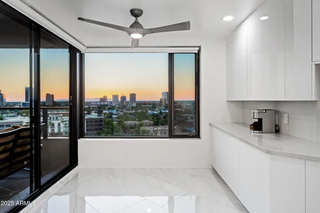 a large white kitchen with a large window