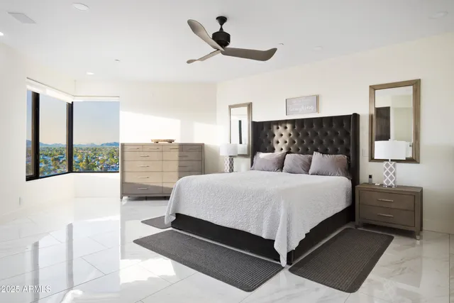 a bedroom with a large bed and a window