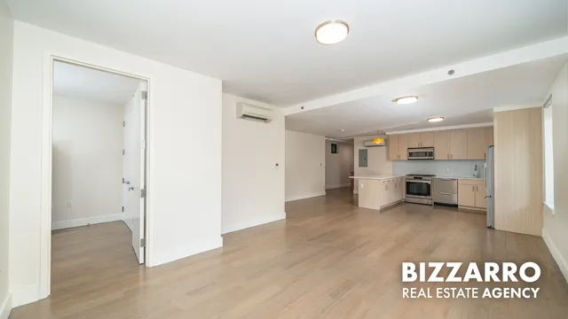 a kitchen with a refrigerator and a stove top oven