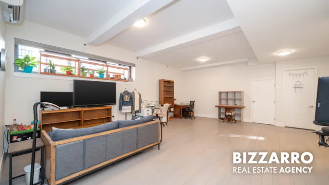a view of a livingroom with furniture and a flat screen tv