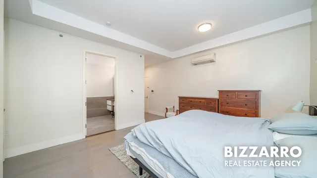 a bedroom with a bed and a view of bathroom