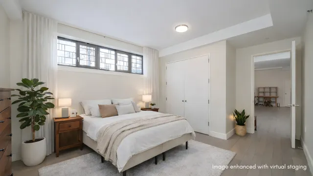 a kitchen with a refrigerator a stove a sink dishwasher a dining table and chairs with wooden floor