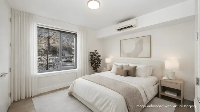 a bedroom with a bed and a potted plant