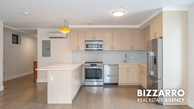 a kitchen with stainless steel appliances granite countertop a stove a microwave and a refrigerator