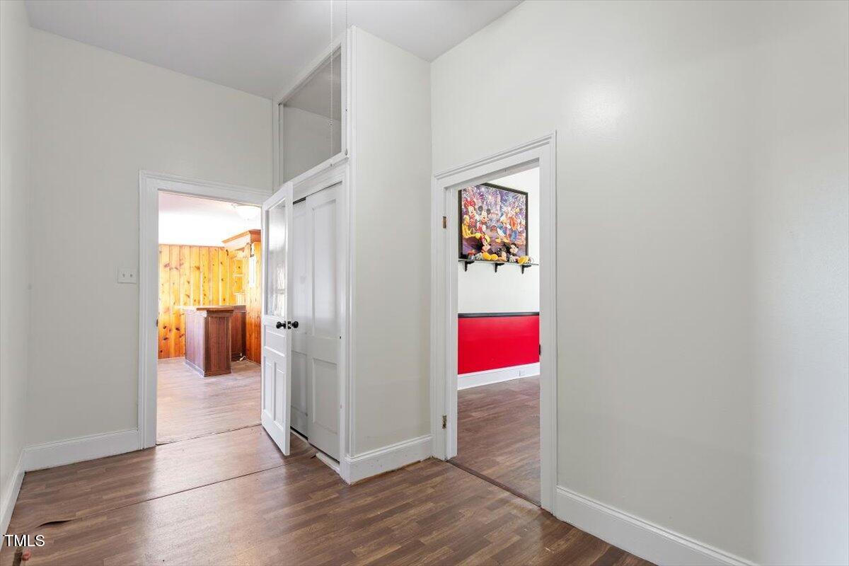 123 King Road Warrenton, NC 27589 - Photo 15 of 24 a view of a hallway with wooden floor and red walls