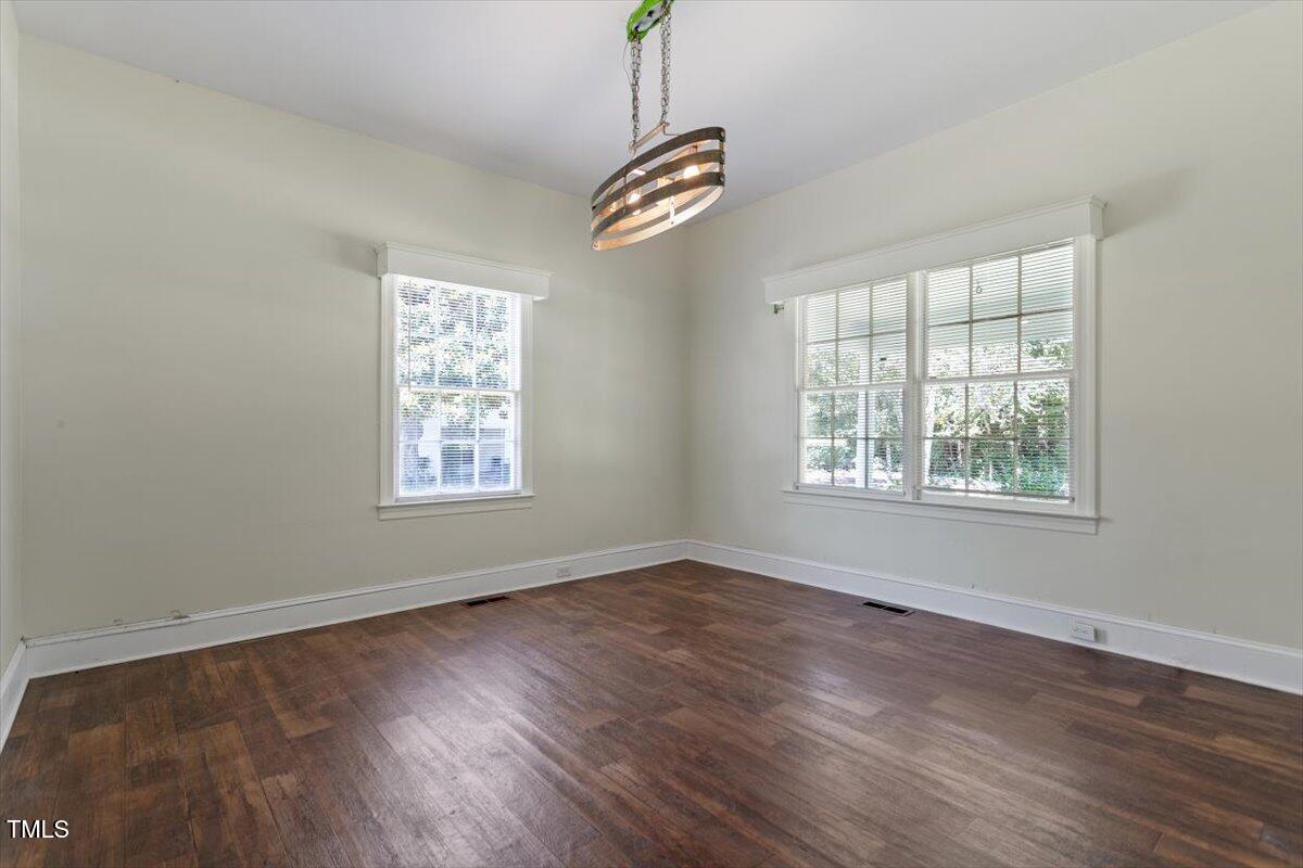 123 King Road Warrenton, NC 27589 - Photo 17 of 24 a view of an empty room with wooden floor and a window