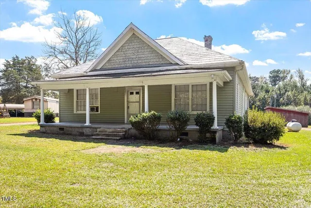 a view of a house with swimming pool and garden