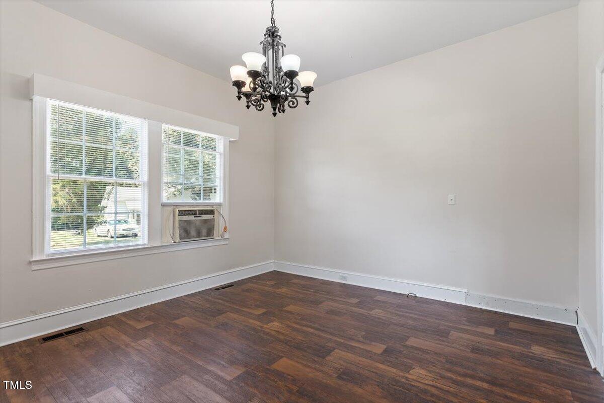 123 King Road Warrenton, NC 27589 - Photo 4 of 24 a view of an empty room with wooden floor and a window
