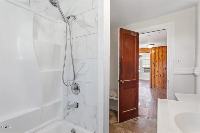 a bathroom with a shower and a tub