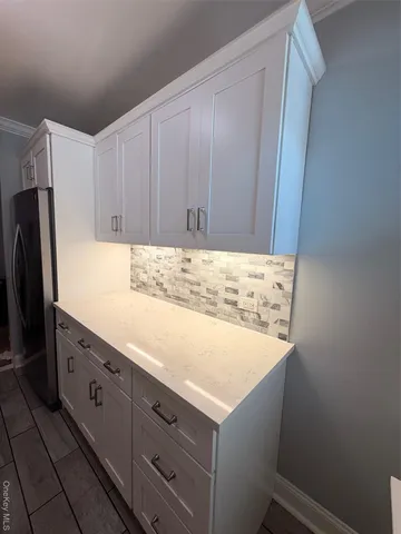 a room with cabinets and refrigerator