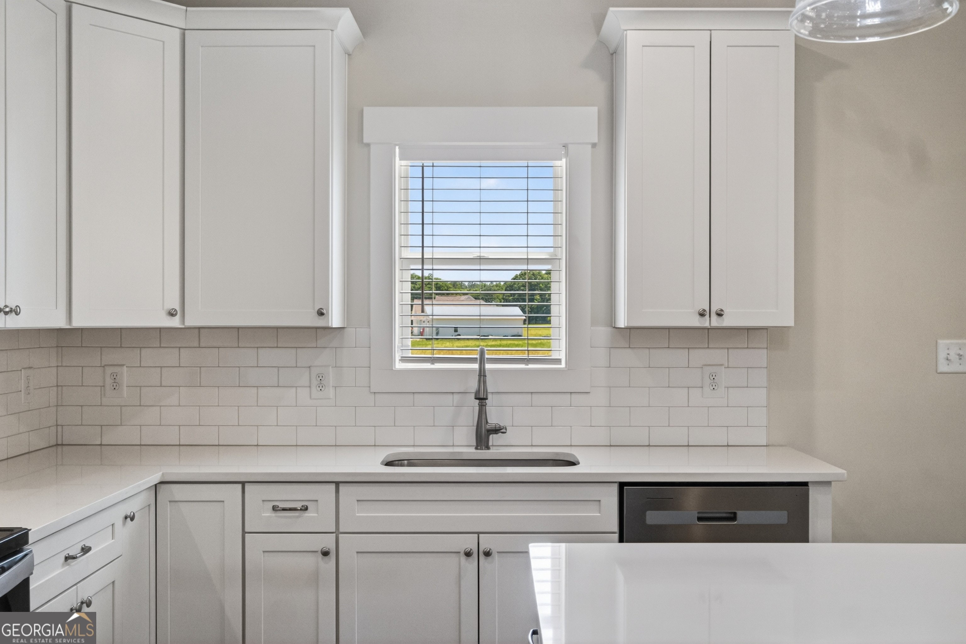 1350-c O Draper Road Comer, GA 30629 - Photo 31 of 47 a kitchen with stainless steel appliances white cabinets and a window