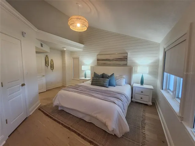 a bedroom with a bed and a chandelier