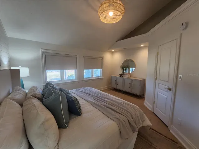 a bedroom with a bed and mirror