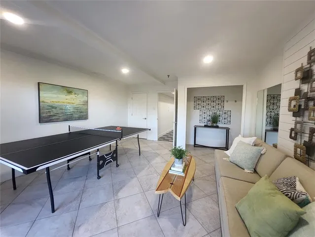 a living room with furniture a rug and a window