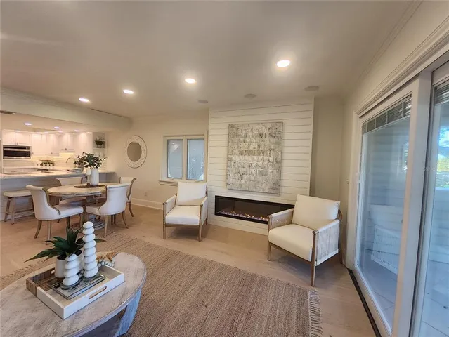 a living room with fireplace furniture and a wooden floor