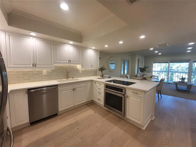 a kitchen with a stove sink and cabinets