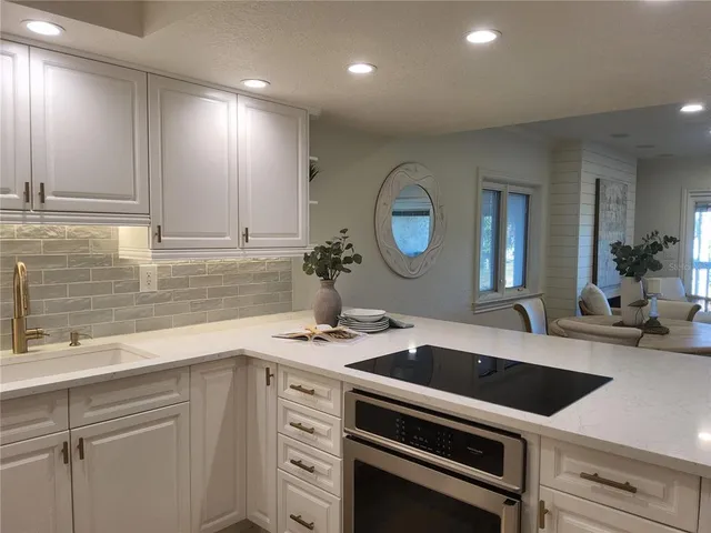a kitchen with a sink cabinets and stainless steel appliances