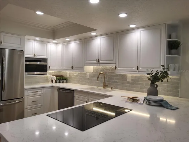 a kitchen with a sink stainless steel appliances and cabinets