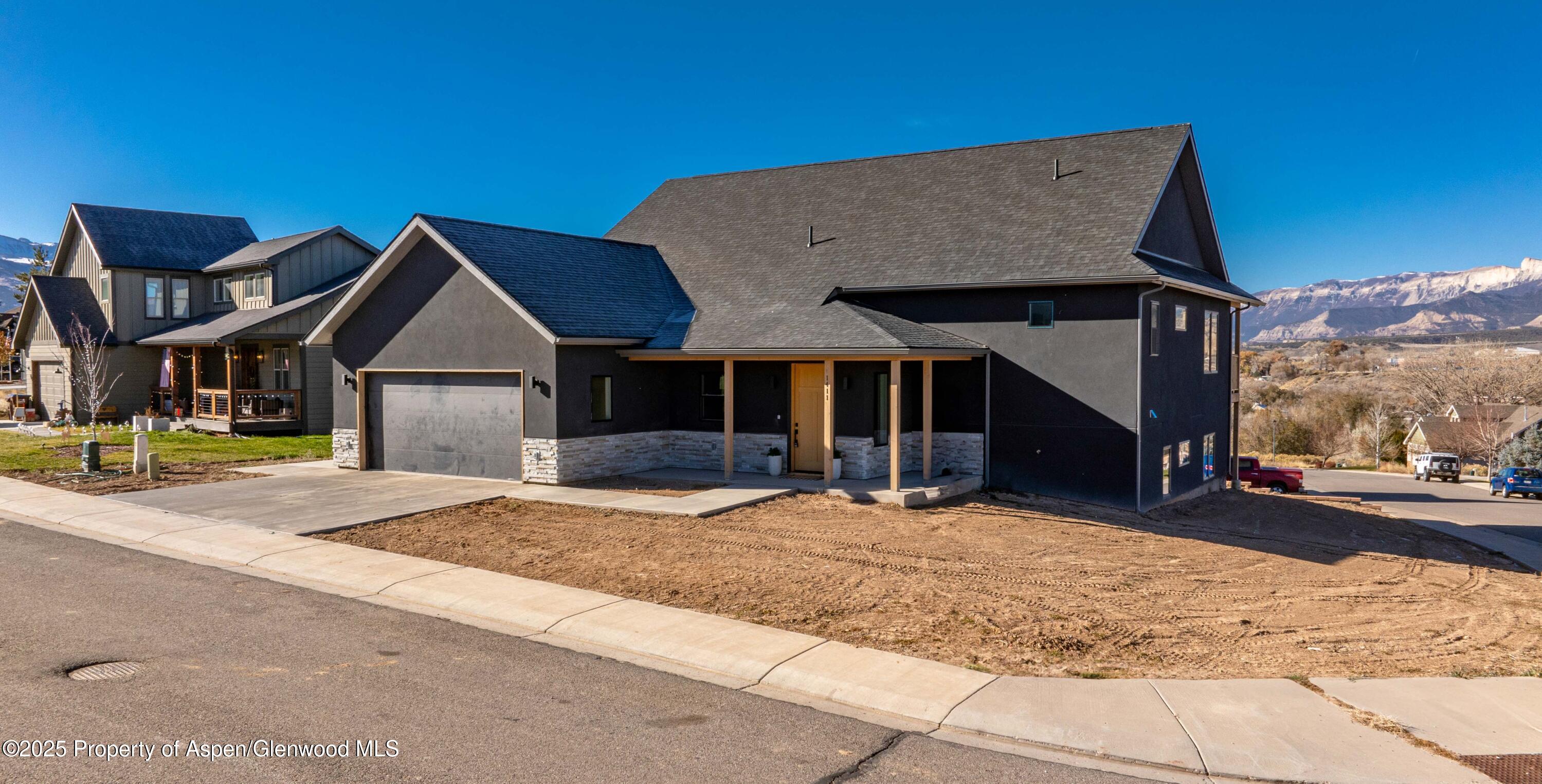 1411 Rifle Heights Drive Rifle, CO 81650 - Photo 1 of 31 a front view of a house with a yard