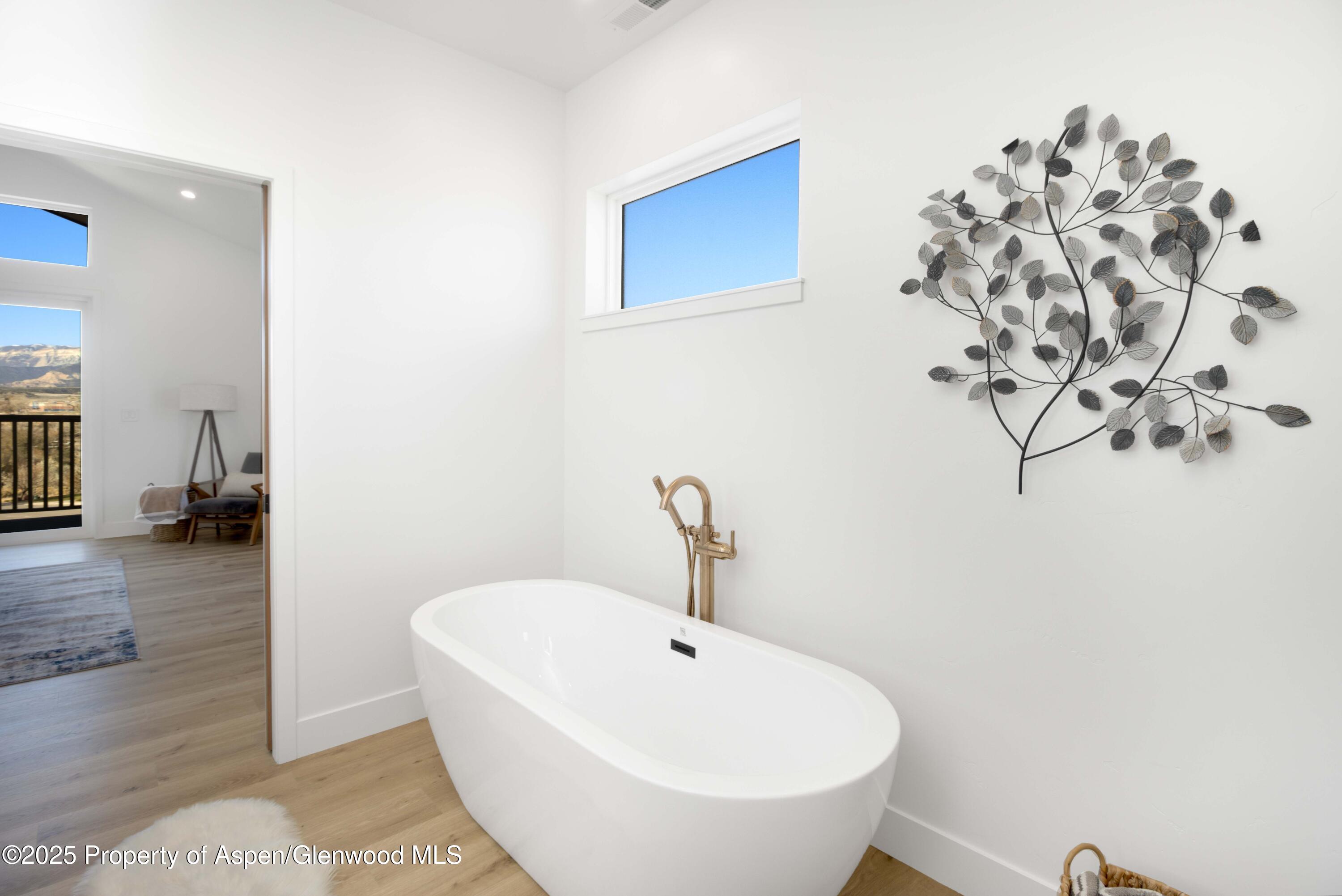 1411 Rifle Heights Drive Rifle, CO 81650 - Photo 11 of 31 a bathroom with a sink and a mirror