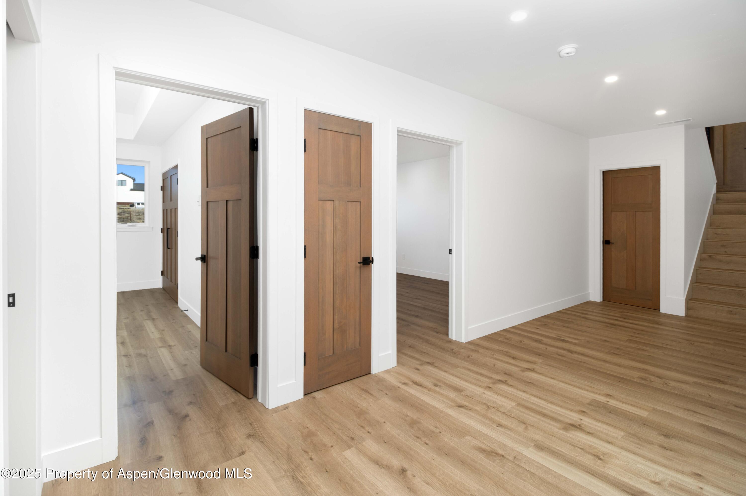 1411 Rifle Heights Drive Rifle, CO 81650 - Photo 18 of 31 a view of an empty room with wooden floor