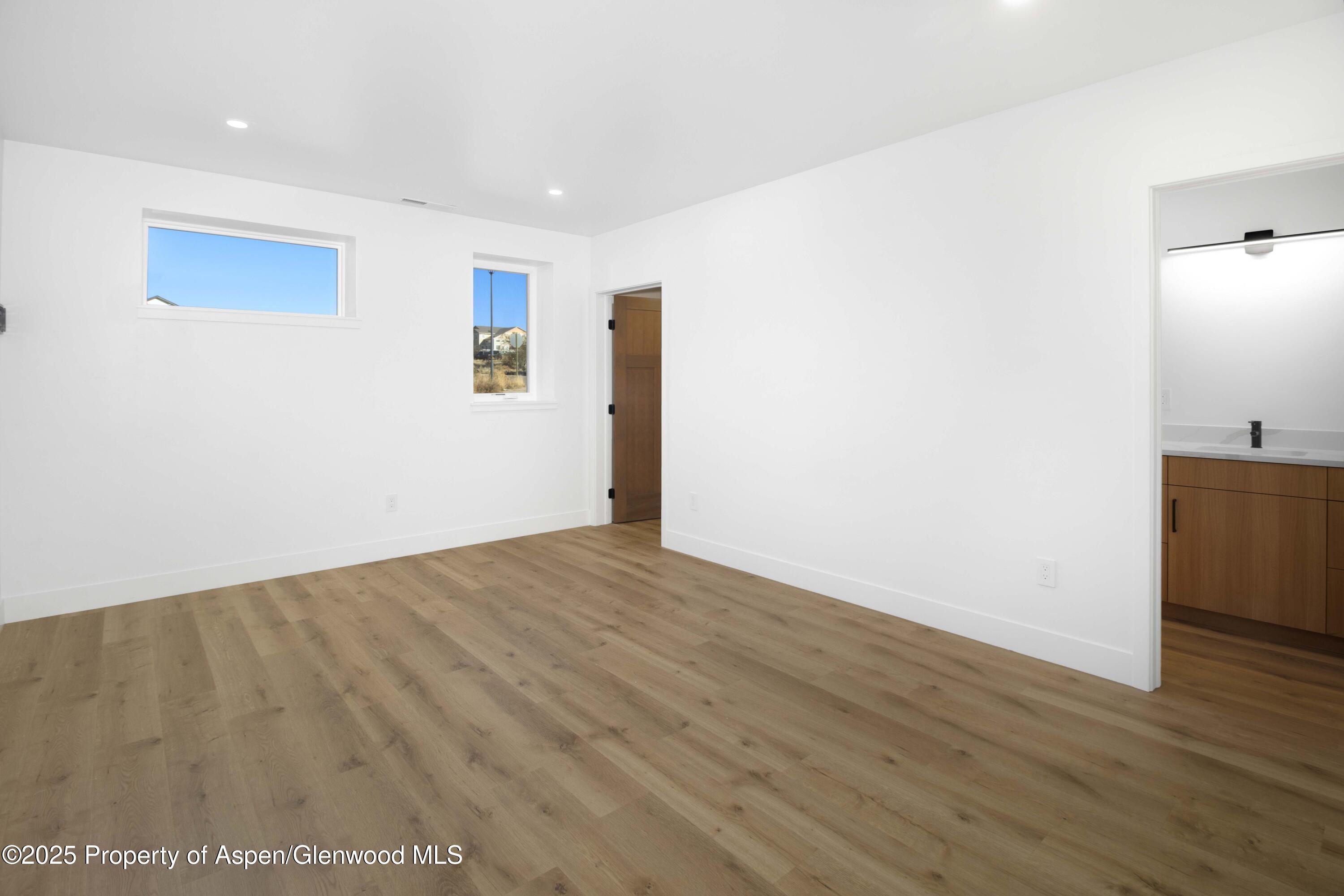 1411 Rifle Heights Drive Rifle, CO 81650 - Photo 21 of 31 a view of empty room with wooden floor