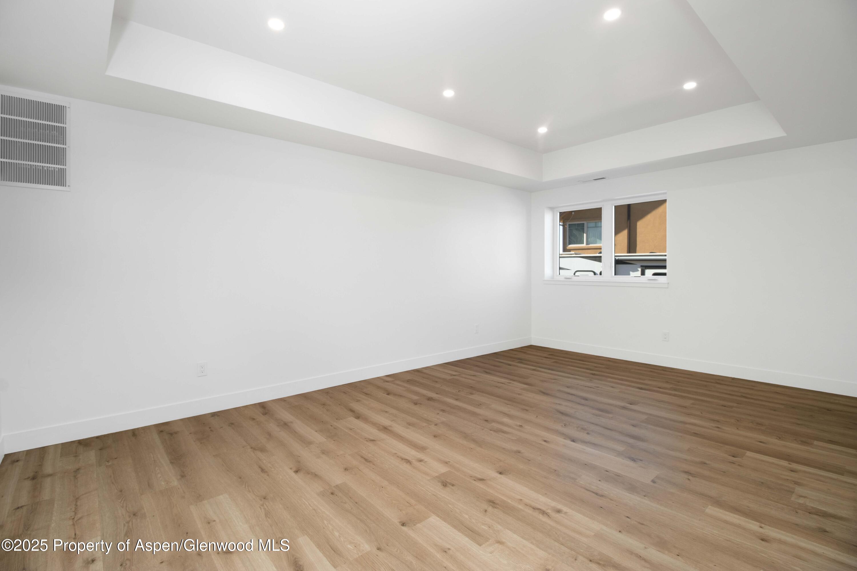 1411 Rifle Heights Drive Rifle, CO 81650 - Photo 23 of 31 a view of empty room with wooden floor