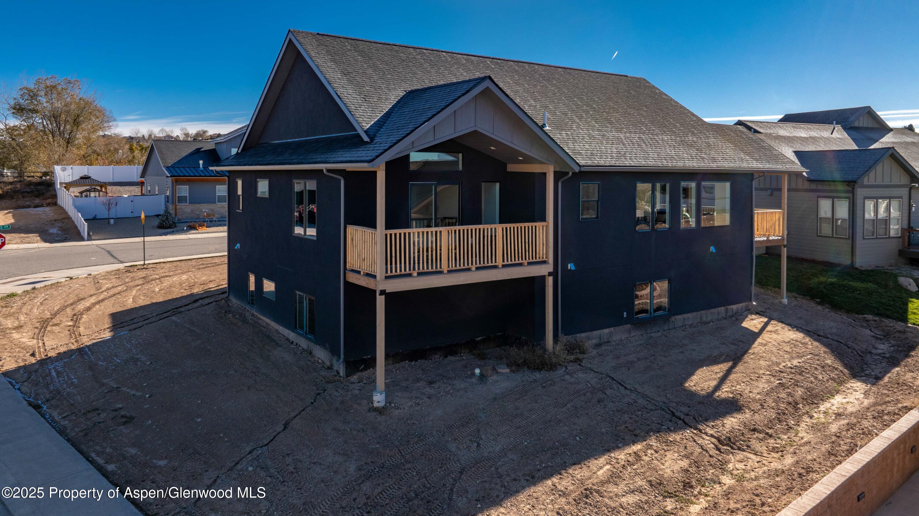 1411 Rifle Heights Drive Rifle, CO 81650 - Photo 27 of 31 a front view of a house with a yard