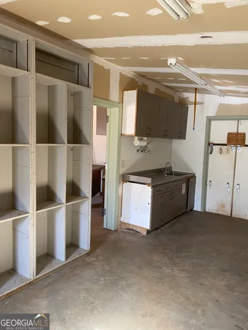 a view of kitchen with refrigerator and microwave