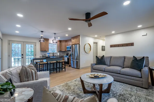 a living room with furniture and a wooden floor