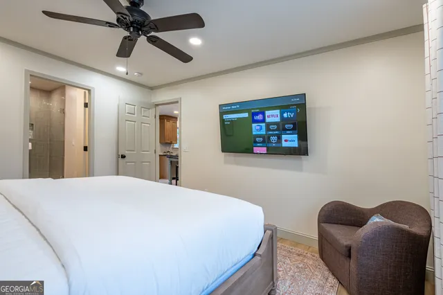 a bedroom with a bed and a painting on the wall