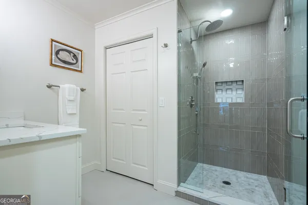 a bathroom with a shower and a sink