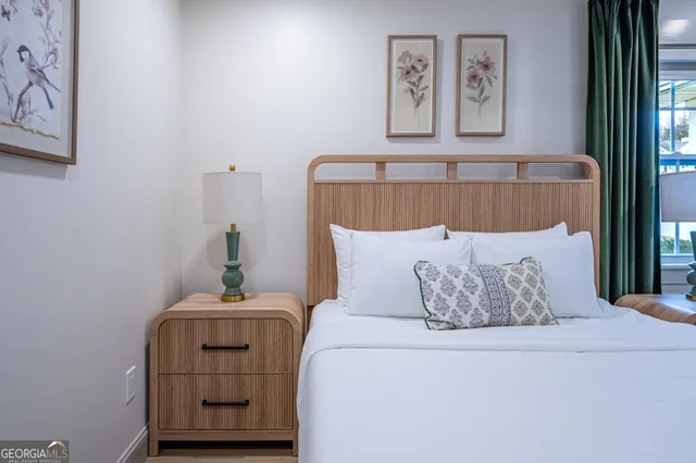 a bed sitting in a bedroom next to a window