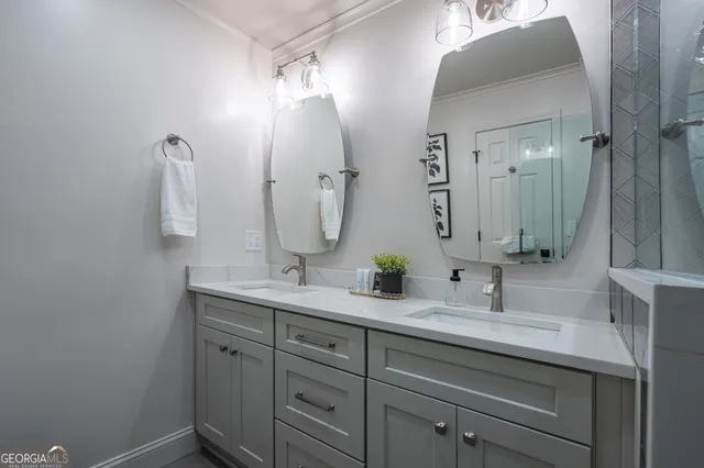 a bathroom with a double vanity sink and mirror