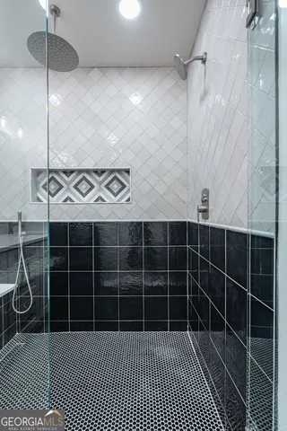 a bathroom with a glass door shower and a bathtub