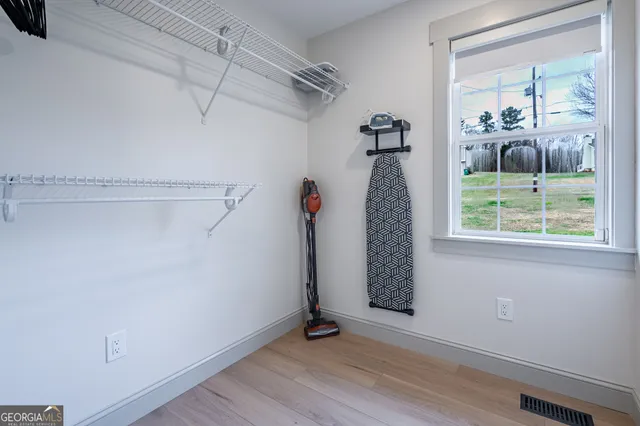 a view of a room with wooden floor and windows
