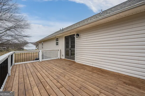 a view of backyard with a deck