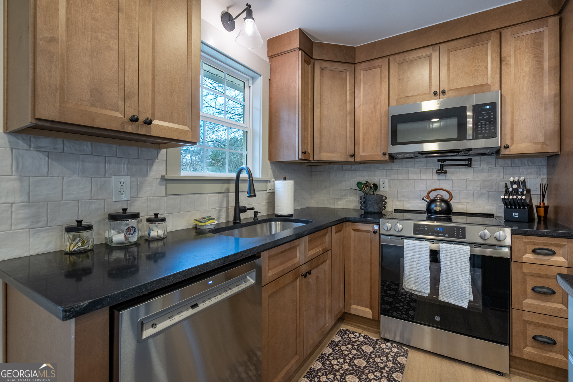 26 Jennifer Lane Rydal, GA 30171 - Photo 4 of 35 a kitchen with stainless steel appliances granite countertop a sink stove and microwave