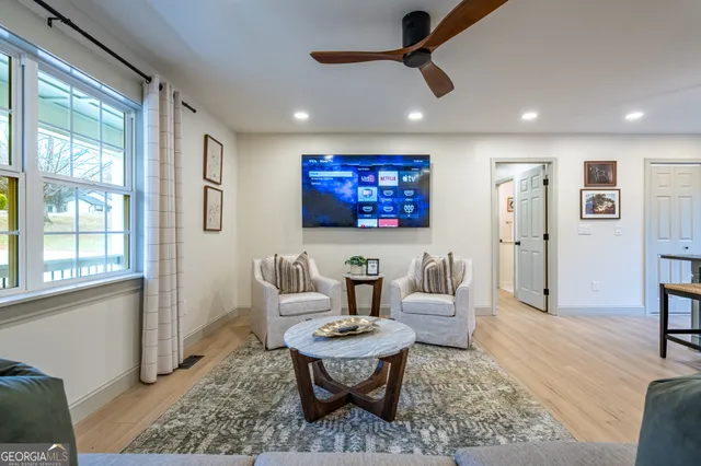 a living room with furniture and a large window