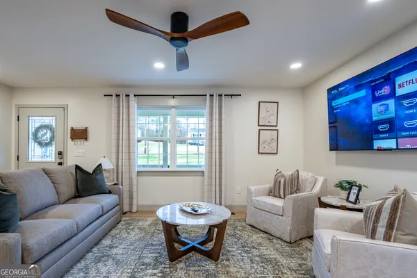 a living room with furniture and a large window