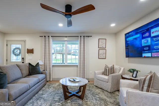 a living room with furniture and a large window