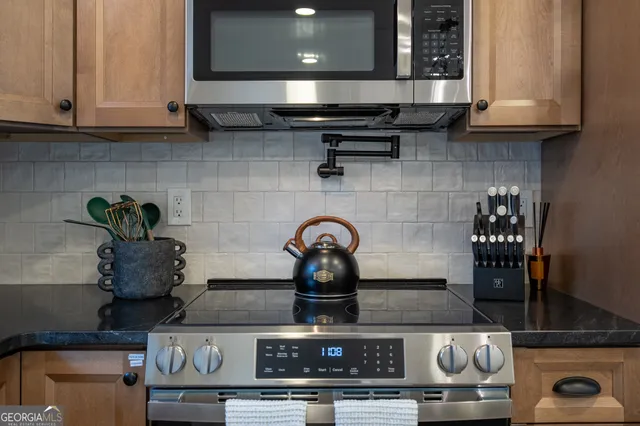 a close view of stove with kitchen island