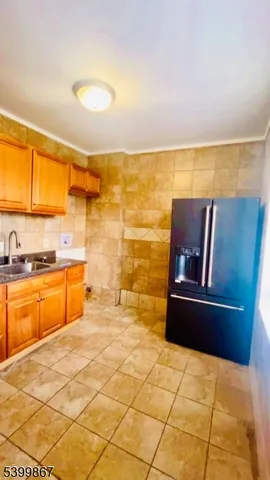 a kitchen with stainless steel appliances kitchen island granite countertop a refrigerator and a stove top oven