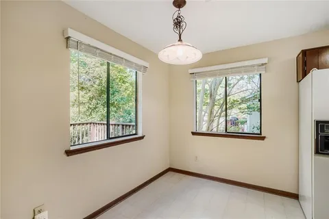 an empty room with windows and outdoor view
