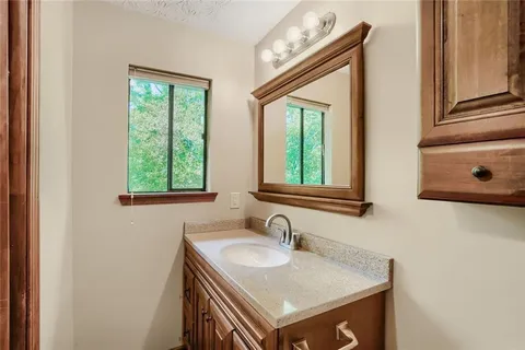 a bathroom with a sink a vanity and a window