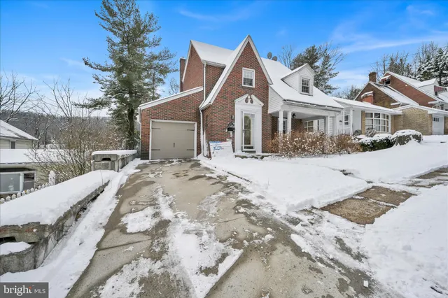 a view of a white house with a yard covered in snow