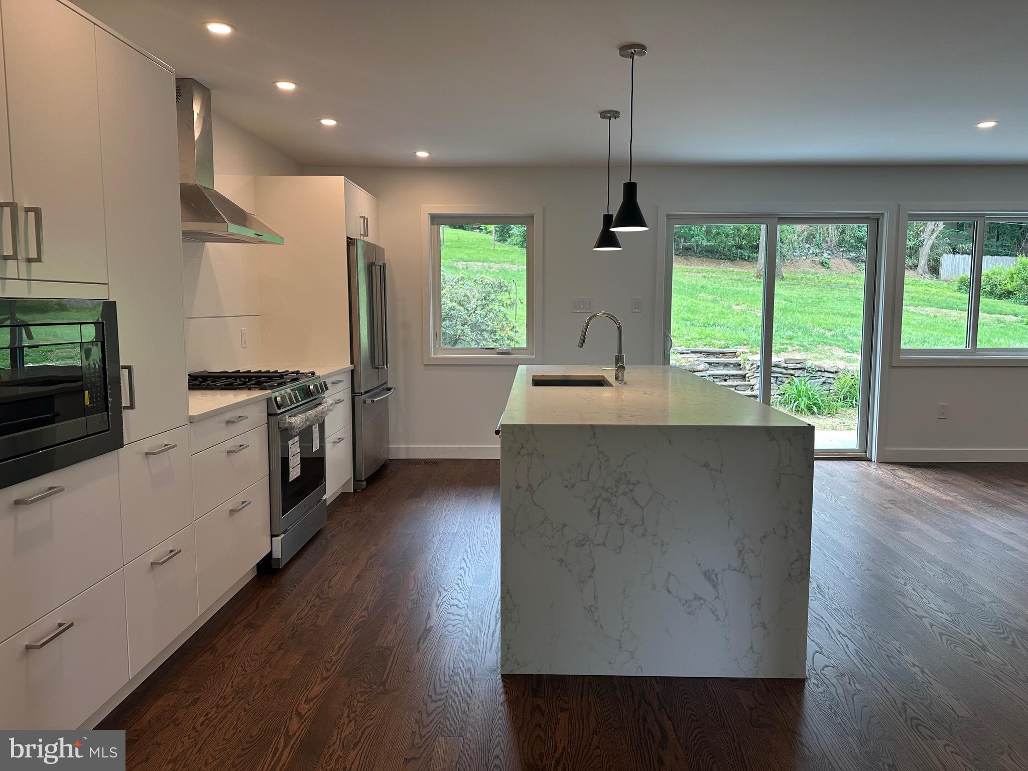 713 Woodfield Road Villanova, PA 19085 - Photo 3 of 36 a kitchen with stainless steel appliances granite countertop a sink a stove and a wooden floors