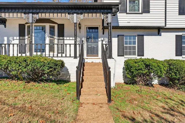 a view of a house with potted plants