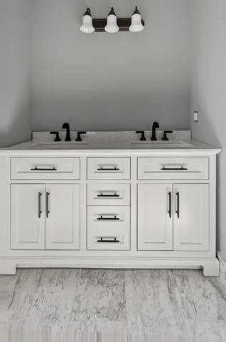 an empty room with wooden floor chandelier fan and windows